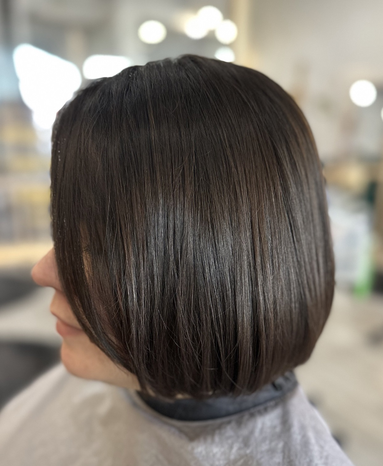 A stylist demonstrating how to style short hair for a chic, polished look